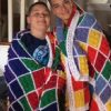 19989692_448817182171844_4165668017430288072_n Two people holding a finished LEGO-inspired crochet blanket